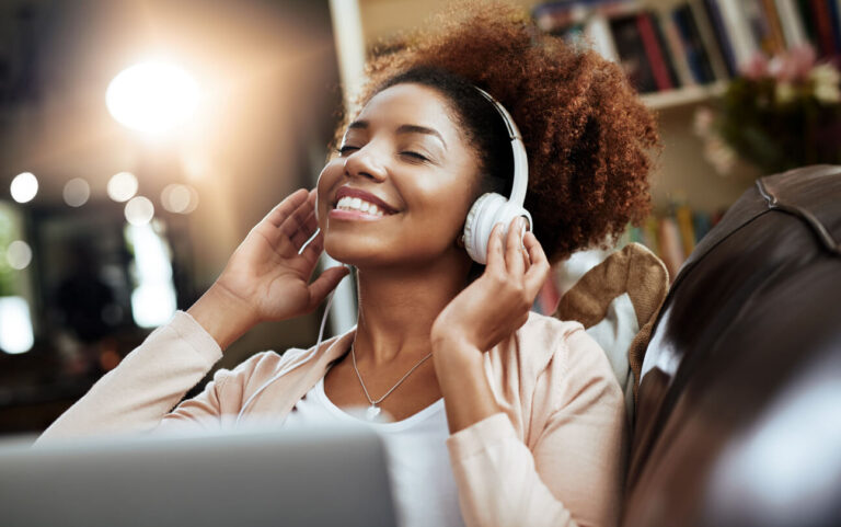 A woman smiling as she listened to music in her headphones