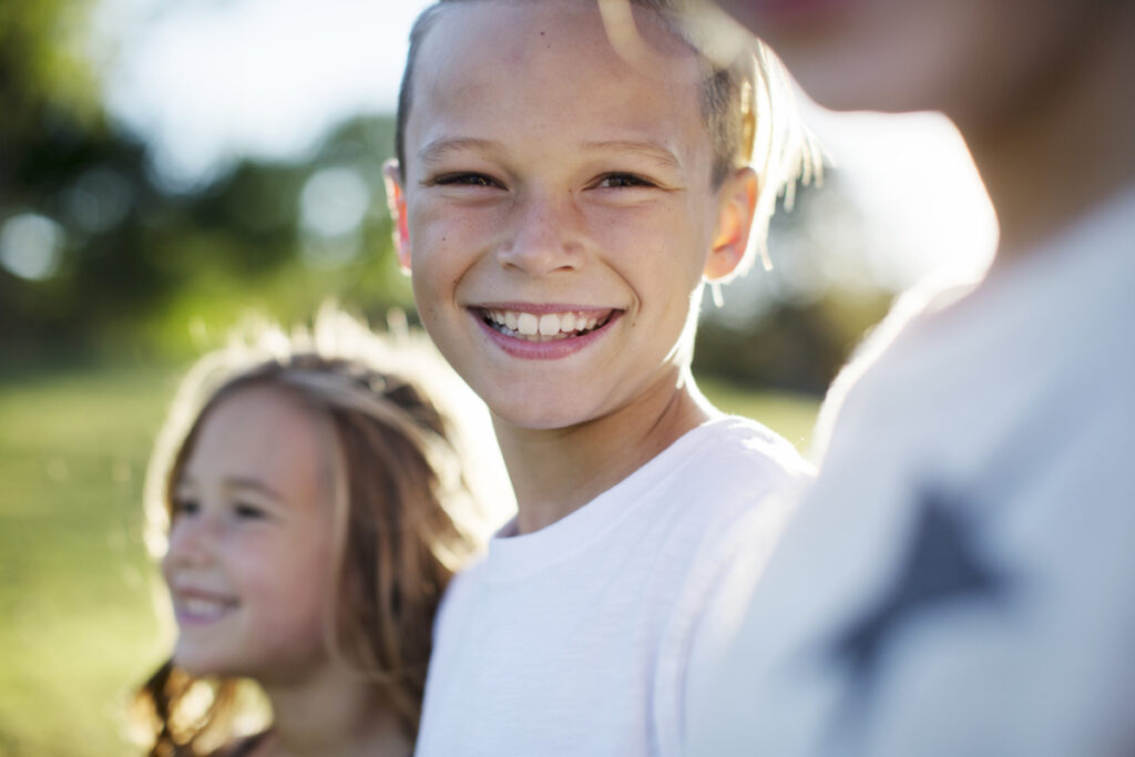 A group of smiling kids outside