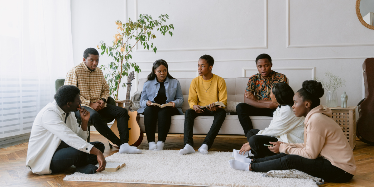 group of young adults having a time of Bible study and worship together